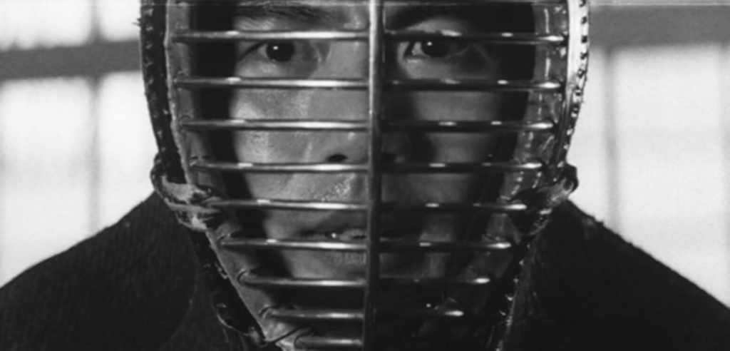 A black and white photo of a man wearing a protective face mask